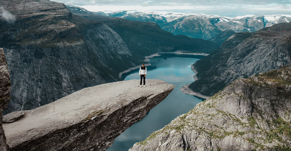 panoramica hombre en montaña y lago